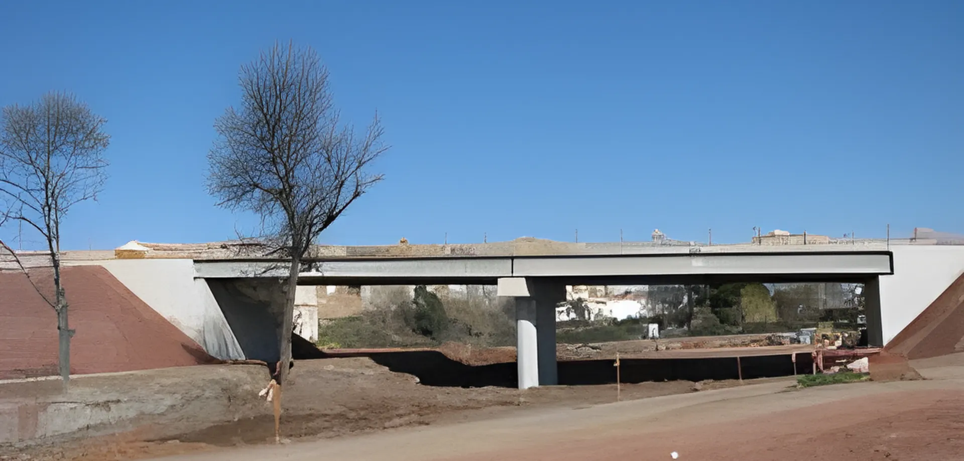 Paso superior de vigas de hormigón con terraplenes recién perfilados